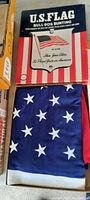 Original box with vintage U.S. Flag Bull-Dog Bunting branding and a partially visible 50 star flag folded inside.