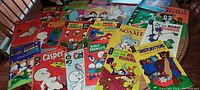 Wide overview of comic book lot with visible comic covers including Aristokittens, Casper, Huey Dewey Louie, Hot Stuff, Road Runner, and Disney characters.