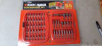 Full view of the 54-piece Black and Decker screwdriving set in its red plastic case showing all bits and tools neatly arranged.