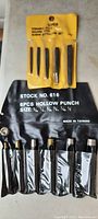 Yellow display holder with six hollow punch tools in original packaging