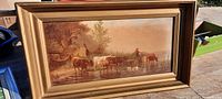 Front view showing chromolithograph with cattle and herder in an ornate frame