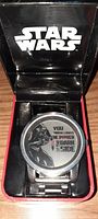 Star Wars wristwatch face showing Darth Vader and slogan 'You don't realize the power of the dark side'.