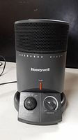 Front view of Honeywell surround heater showing control panel with fan/turbo and thermostat knobs, power light, and Honeywell logo.