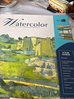 Box top showing watercolour landscape artwork and kit contents listed