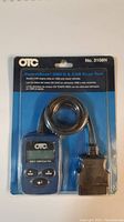 Clear front view of the OTC PocketScan OBD II & CAN Scan Tool in original packaging showing scan tool, cable, and OBD connector.