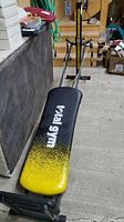 Long view of Total Gym Xtreme with padded bench on metal frame and pulley system