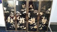 Four black lacquer panels displayed side by side showing complete set