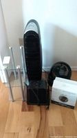 Full view showing all items in lot: two fans, two heaters, and glass shelf