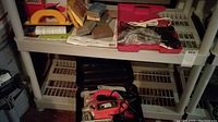 Full shelf view of all tools and sanding materials included in the lot