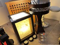 Wide shot of three table lamps and accessories including LED lights and light bulbs.