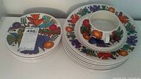 Two stacks of decorative plates side by side with a mug placed on top
