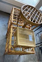 Top view of three stacked rattan tables showing their sizes and shapes.