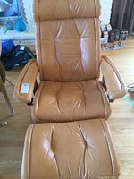 Front view of recliner and ottoman on hardwood floor