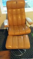 Full front view of recliner and ottoman showing overall design and color