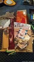 Top view of multiple stained glass pieces and several stained glass craft books arranged on a surface.