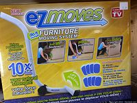 EZ Moves Furniture Moving System packaging showing lifter tool and slides, emphasizing unique power bar design.