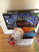 Large boxed Fantasma Magic set showing 200+ tricks and DVD tutorial, fabric storage bin with toys and ball on top.