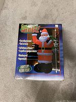 Front of sealed product box showing image of Giant Airblown Inflatable Santa, height scale, feature list