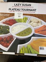 Box showing packaging of the Lazy Susan set with 5 porcelain serving pieces, 16-inch diameter, microwave and dishwasher safe