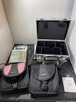 Photo showing all items: three Nintendo DS cases (two soft, one hard aluminum) and Bookworm game cartridge in case.