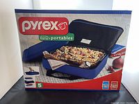 Box showing Pyrex Portables 5 piece set with image of glass dish, insulated carrier bag, and hot/cold packs