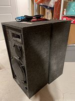 Pair of black Samaurai Pro Series speakers angled together, showing side and top.