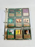 Photo showing nine Magic the Gathering cards stored in a clear sleeve in a binder. Cards include various fantasy creatures and abilities, green and artifact colors visible.