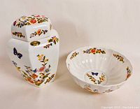 Ginger jar and bowl side by side showing floral and butterfly decorations on white bone china
