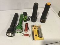 Group shot of 10 flashlights showing all items in lot