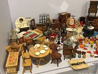 Overview of assorted miniatures including wooden furniture, textiles and small accessories