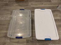 Two clear plastic under bed storage bins shown, one with lid off and one with the lid on.