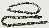 Two 7-inch silver bracelets laid side by side showing overall length and style