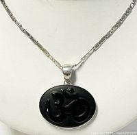 Front view of the 925 silver chain with black oval pendant showing the carved symbol detail