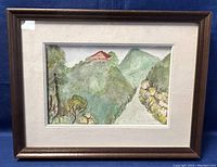 Framed landscape painting of a hill with a house, greenery, and path.