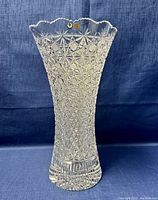 Full view of the large crystal vase showing its overall shape, heavy cut pattern, and scalloped rim.