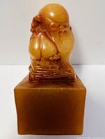 Front view of carved holy man figurine on a Shoushan stone seal base