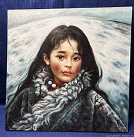 Full view of oil painting portrait of young girl in fur garment with bead necklace on linen canvas against dark blue background