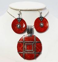 Necklace and earrings set displayed on white bust, showing coral stones and silver details