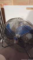 Front view of Patton high velocity fan with visible blue blades and metal grille.