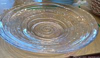 Top down view of the clear glass bowl showing the spiral and concentric ridge detail.