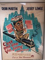 Framed vintage movie poster featuring cartoon Jerry Lewis and Dean Martin with city skyline background.