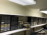 Overview of multiple black and grey organizer cabinets on shelf