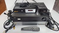 Two stacked units (power conditioner on top, AVR below) with cables and remote in front