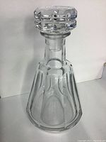 Front view of full decanter with stopper on