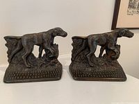 Front view showing the detailed dog figurines in bronze on textured base