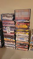 Stack of DVDs and Blu-rays including Jeeves and Wooster and various other movie titles.