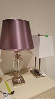 Overall view of both lamps on surface showing relative sizes and shade styles