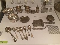 Overhead view of all flatware and serveware pieces on white surface