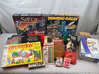 Overview of the assorted games including Operation, Taboo, Master Mind, Yahtzee, Trivial Pursuit, cribbage board, playing cards and others.