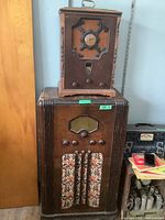 Photo showing two radios stacked, larger Westinghouse floor radio at bottom, smaller General Electric tabletop radio on top.